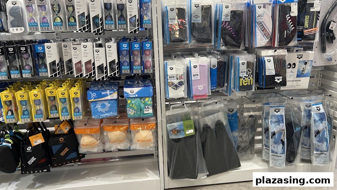 Shelves displaying a wide range of swimming accessories, including goggles, caps, and training aids.