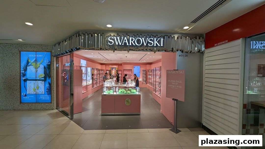 View of the Swarovski store entrance showcasing its sparkling jewelry and pink-themed interior.