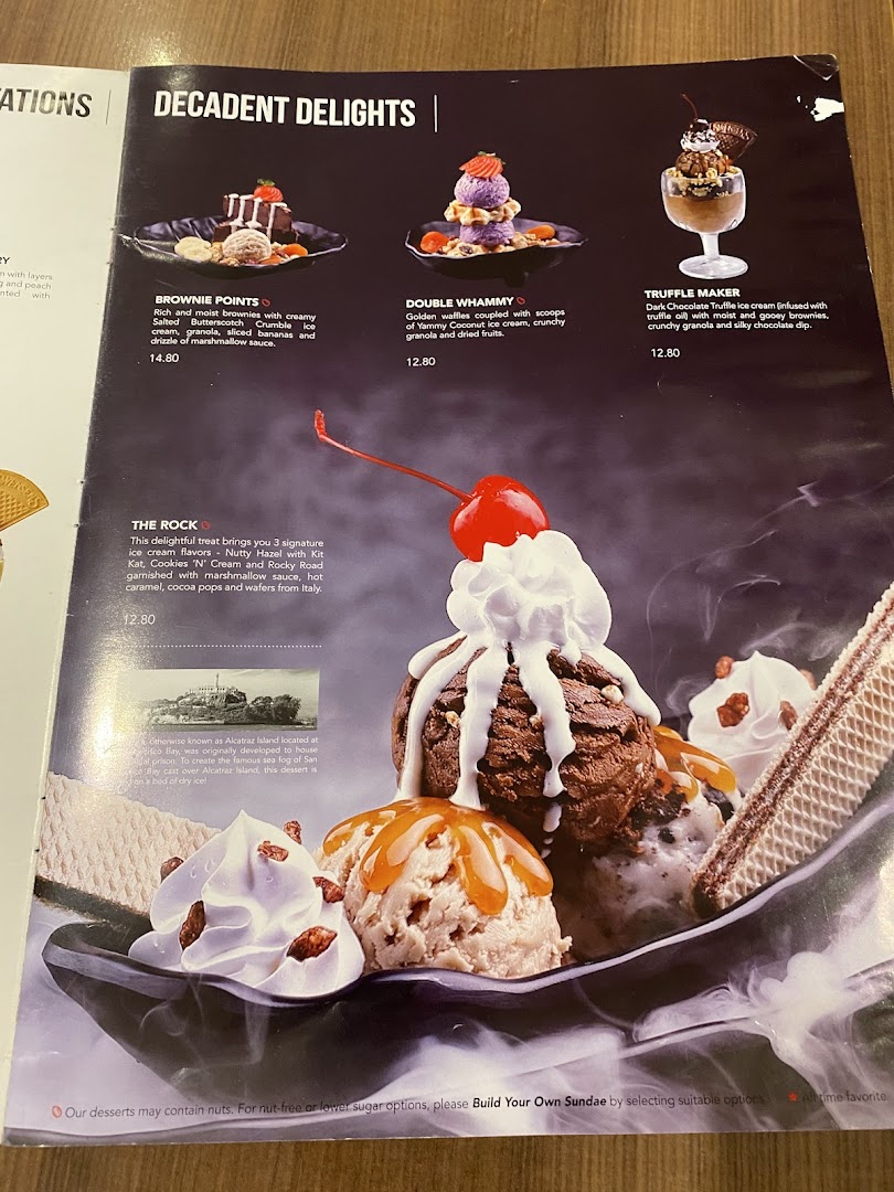 A close-up of Swensen's dessert menu featuring decadent ice cream sundaes and brownie treats.