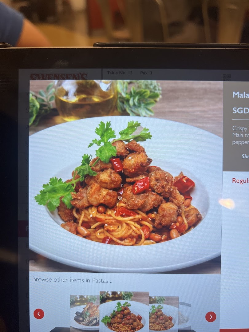 A digital menu screen at Swensen's showcasing a spicy Mala pasta dish with crispy chicken.