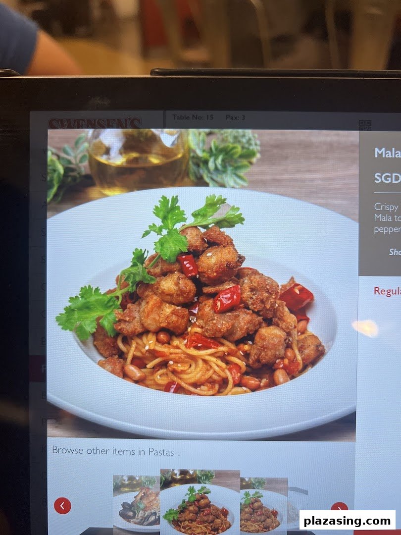 A digital menu screen at Swensen's showcasing a spicy Mala pasta dish with crispy chicken.