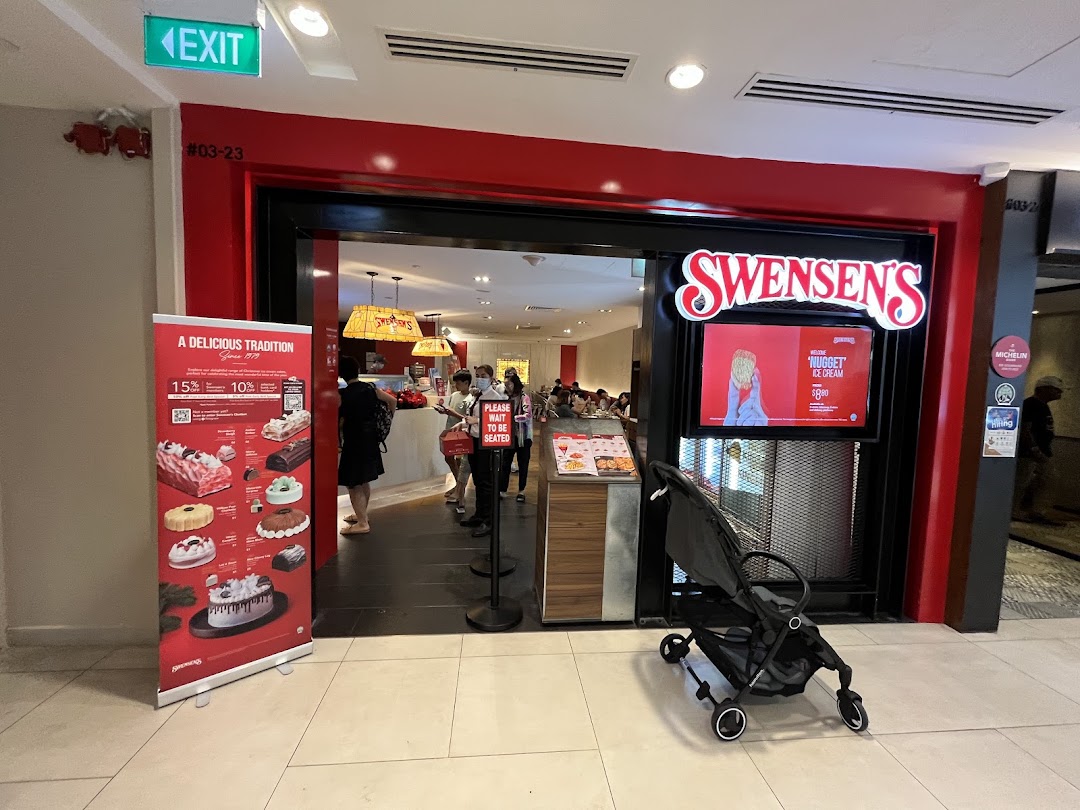 The vibrant red entrance of Swensen's restaurant at Plaza Singapura, featuring a promotional banner and customers inside.