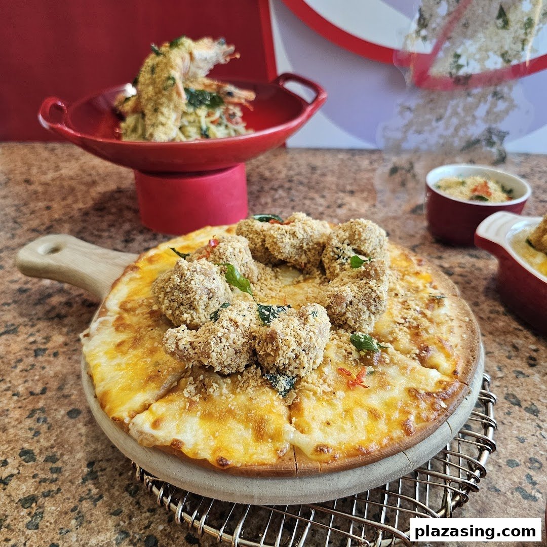 A delicious pizza topped with crispy golden chicken pieces, alongside other delectable dishes from Swensen's.