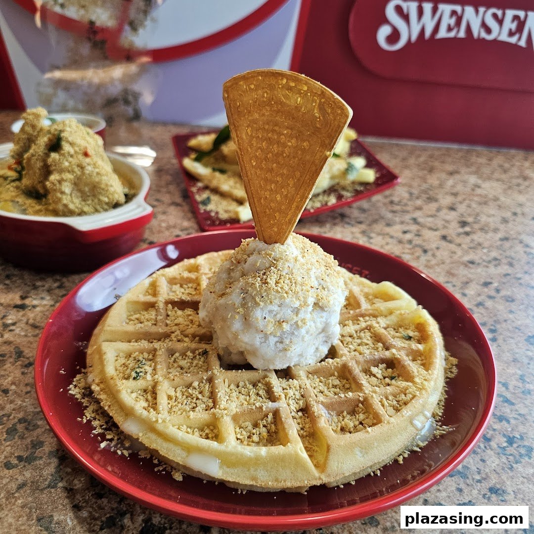 A delicious waffle topped with ice cream and crunchy bits, served on a red plate at Swensen's.