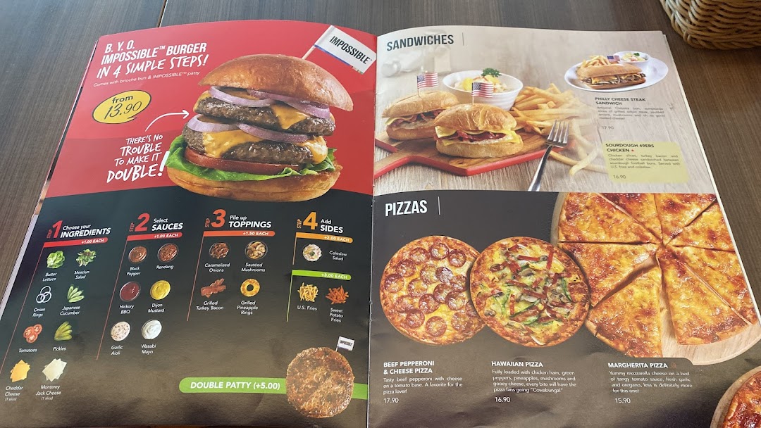 A vibrant menu displaying burgers, sandwiches, and pizzas with prices and descriptions.