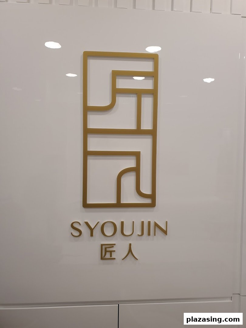 The elegant gold logo and name 'Syoujin 匠人' displayed on a pristine white shop front.