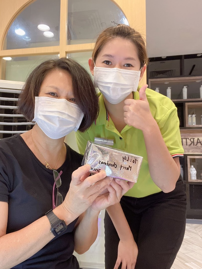 A happy customer and staff member in masks holding a gift, showcasing friendly service.