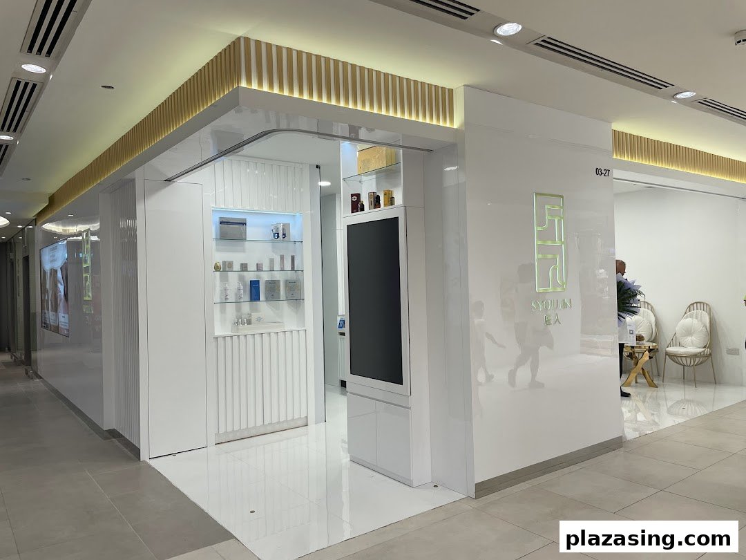 The sleek, modern white facade of Syoujin 匠人 beauty and wellness shop with its illuminated logo.