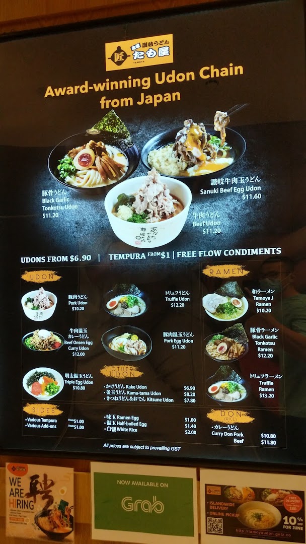 A vibrant menu board showcasing a variety of udon, ramen, and rice bowls with prices and special offers.