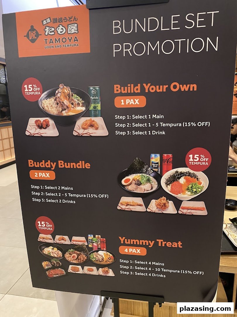 A promotional display board for Tamoya Udon & Tempura, showcasing various bundle set promotions.