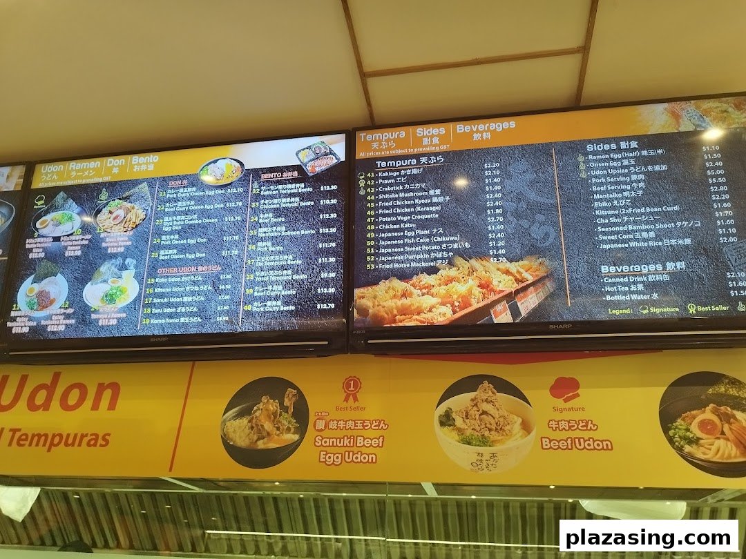 Digital menu boards displaying a wide variety of Japanese udon, ramen, donburi, bento, tempura, sides, and beverages.
