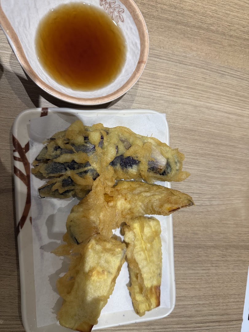 Assorted crispy tempura with a side of dipping sauce, ready to be enjoyed.