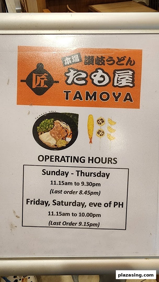 An informational sign for Tamoya Udon, displaying its logo, food illustrations, and detailed operating hours.