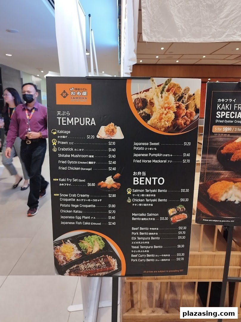 A detailed menu board for Tamoya Udon Tempura, showcasing various tempura and bento options.