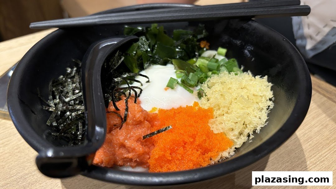 A vibrant bowl of udon with diverse toppings including roe, seaweed, tempura flakes, and a poached egg.