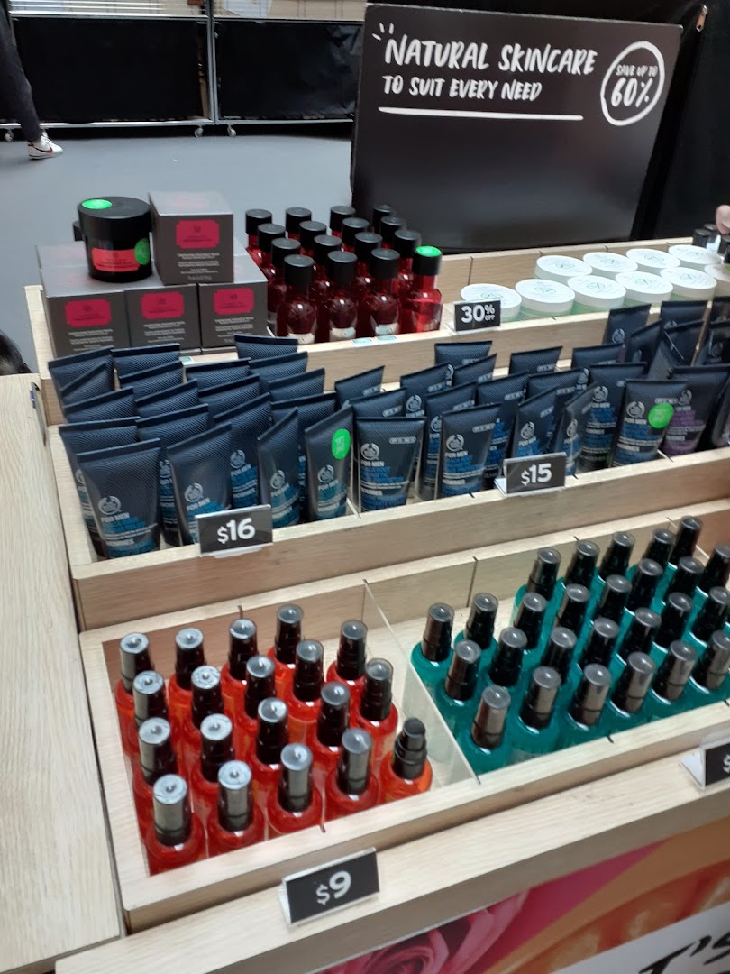 A display of natural skincare and body care products with prices at The Body Shop.