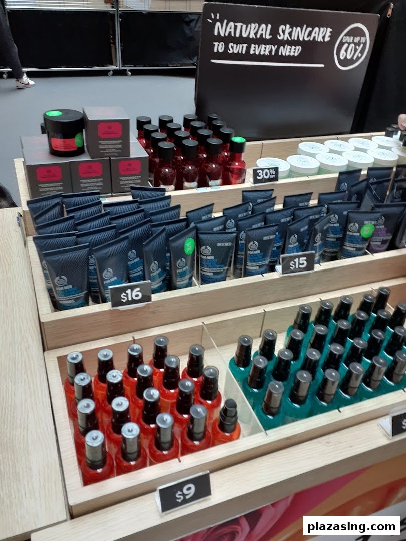 A display of natural skincare and body care products with prices at The Body Shop.