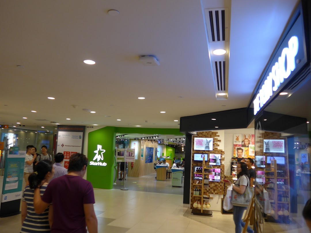 The Body Shop storefront in a bustling mall, showcasing its vibrant products and inviting entrance.