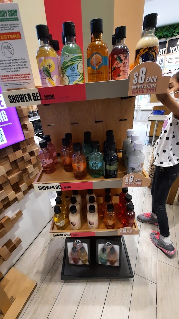 A vibrant display of various shower gels and body care products at The Body Shop.