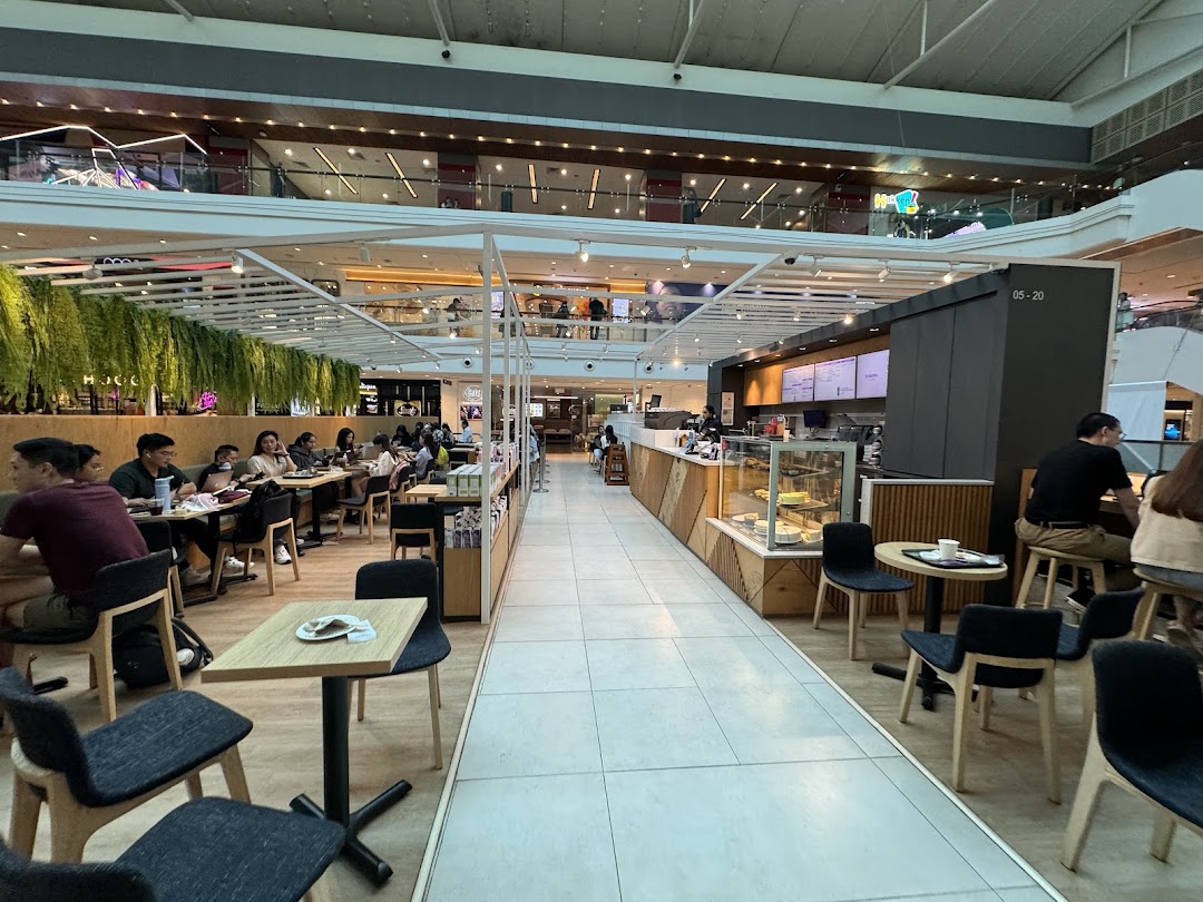 An inviting interior view of The Coffee Bean & Tea Leaf with customers enjoying beverages.