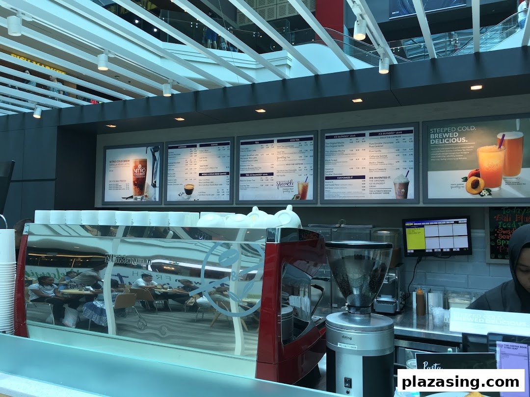 The counter area of The Coffee Bean & Tea Leaf, featuring prominent menu boards and a coffee machine.