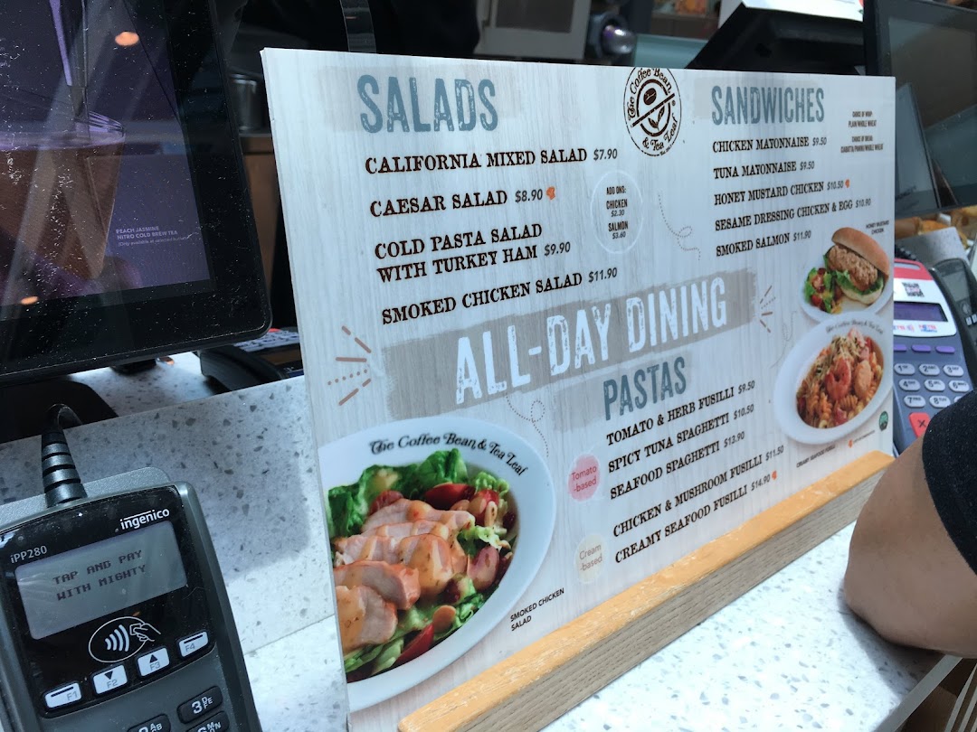 A close-up of an 'All-Day Dining' menu board featuring salads, sandwiches, and pastas.