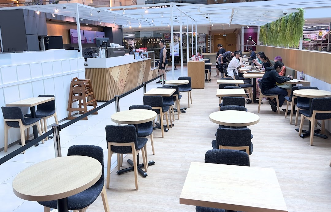 An inviting interior view of The Coffee Bean & Tea Leaf, featuring a service counter and ample seating.