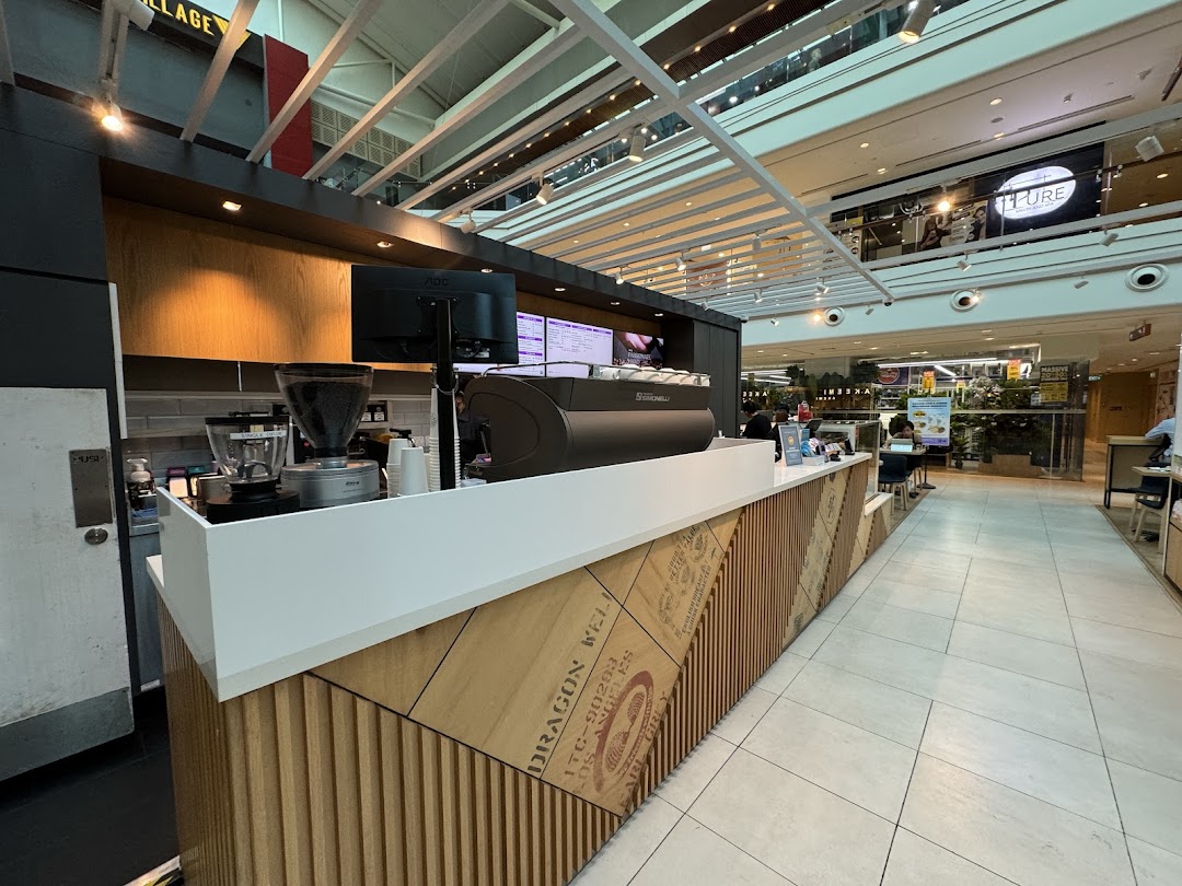 Interior view of The Coffee Bean & Tea Leaf counter with coffee machine and grinder.