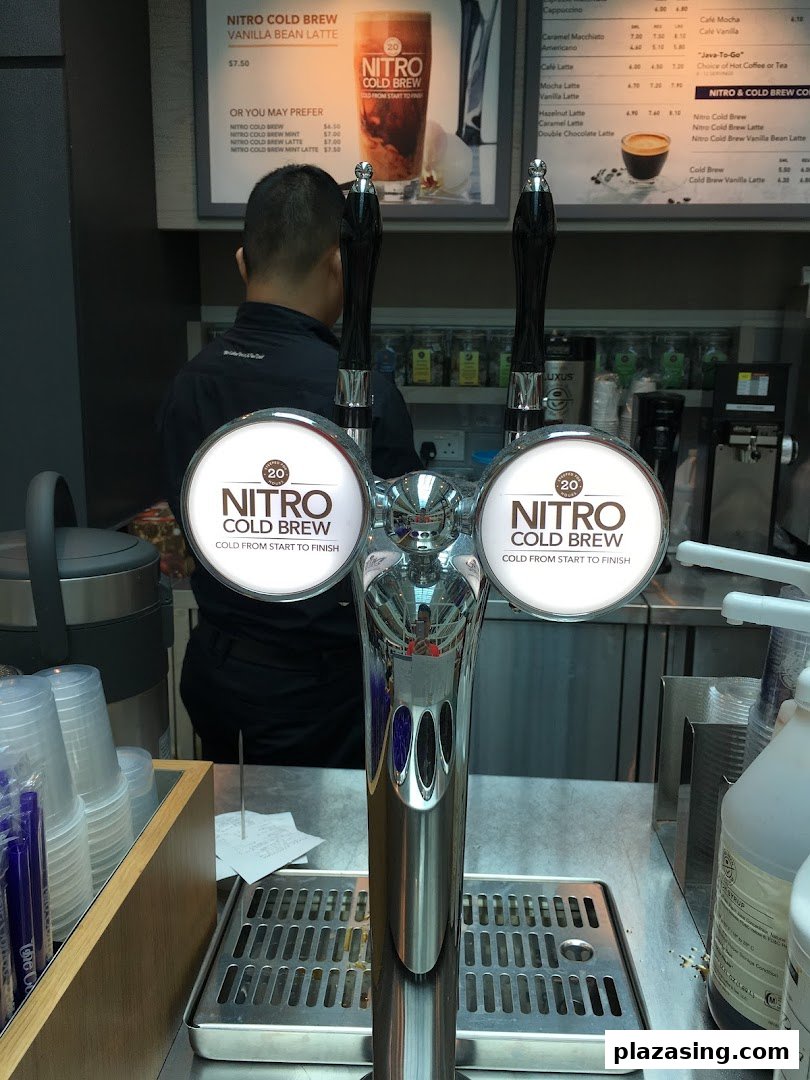 Interior view of The Coffee Bean & Tea Leaf counter featuring nitro cold brew taps and menu boards.