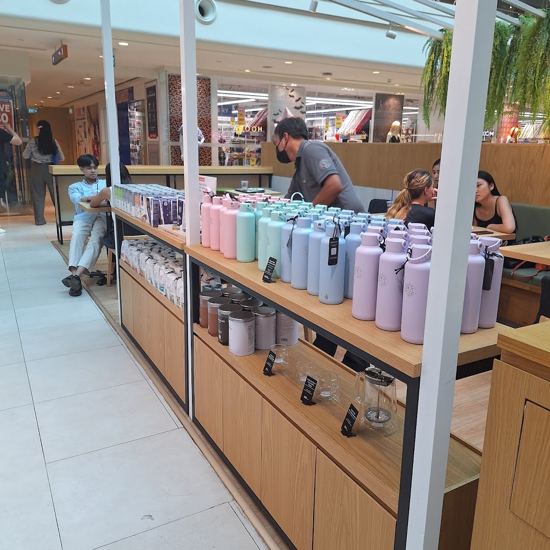 Interior view of The Coffee Bean & Tea Leaf, showcasing colorful merchandise and a cozy seating area.