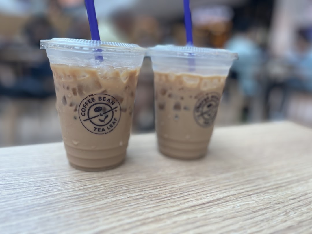 Two refreshing iced coffee drinks from The Coffee Bean & Tea Leaf on a wooden table.