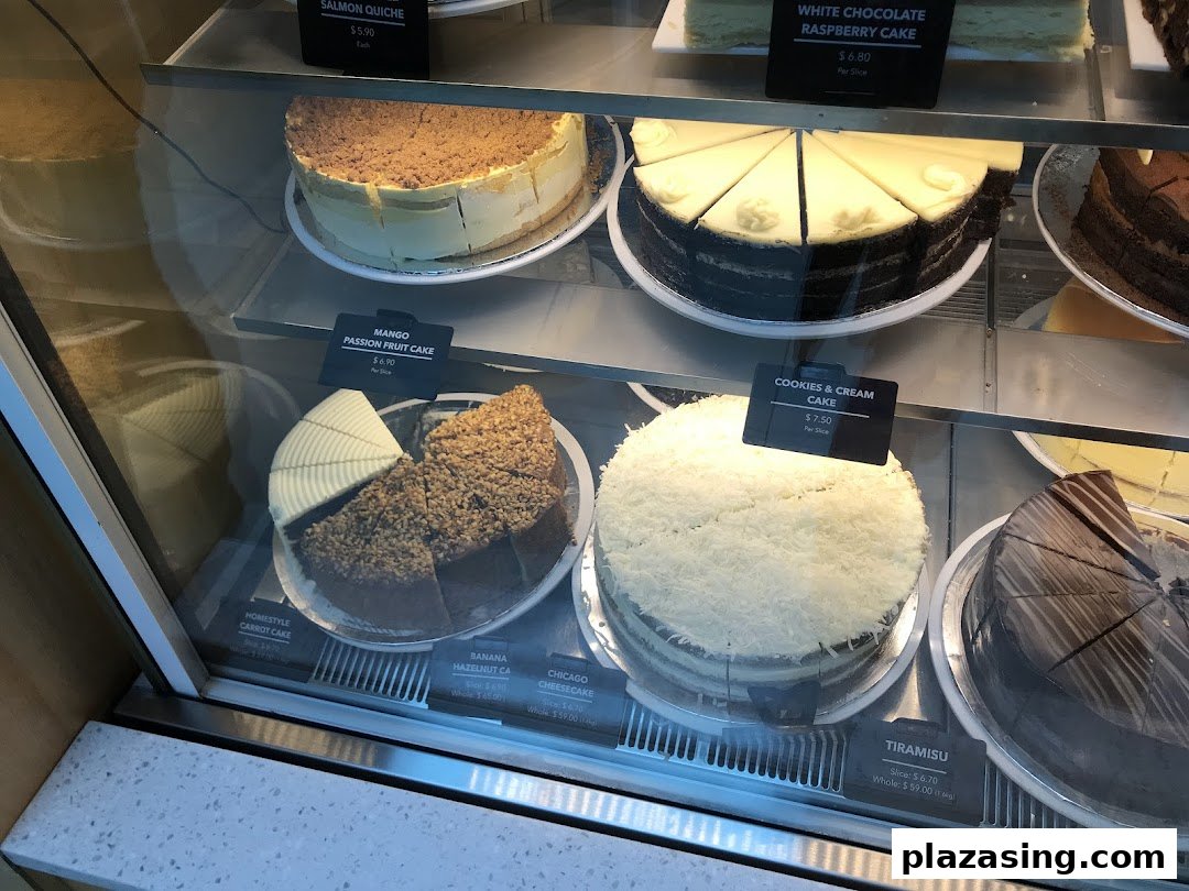 A vibrant display case showcasing a variety of delicious cakes and pastries at The Coffee Bean & Tea Leaf.