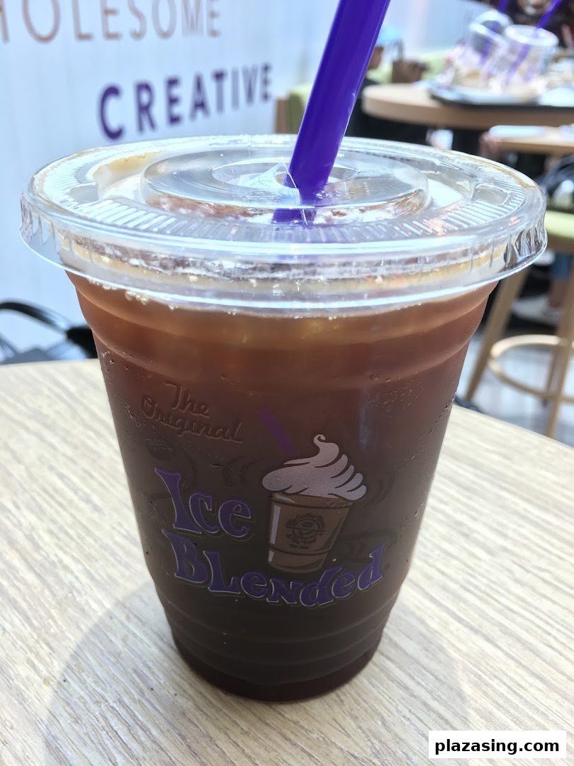 A refreshing iced coffee drink from The Coffee Bean & Tea Leaf with a purple straw.