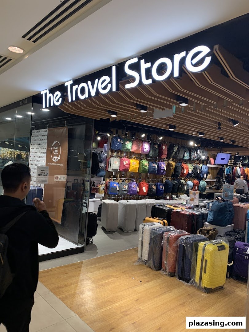 The shop front of 'The Travel Store' showcasing a wide array of colorful backpacks and luggage.