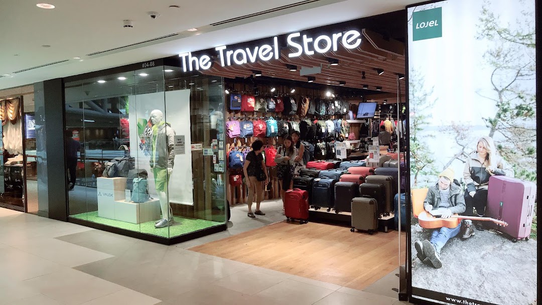 The Travel Store's brightly lit shop front displays a wide selection of luggage, backpacks, and travel accessories.