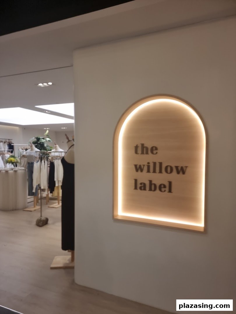 The Willow Label shop front with illuminated signage and a glimpse of the interior.