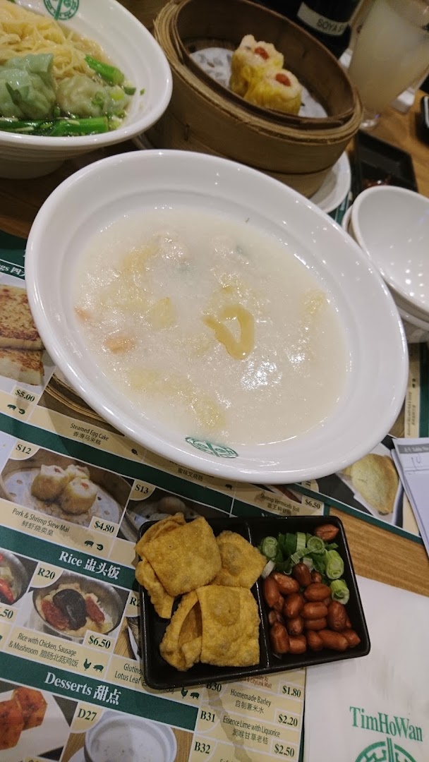 A table laden with various dim sum dishes and congee at Tim Ho Wan.