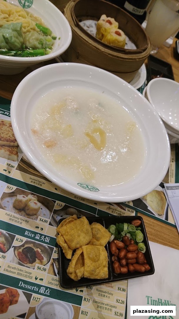 A table laden with various dim sum dishes and congee at Tim Ho Wan.