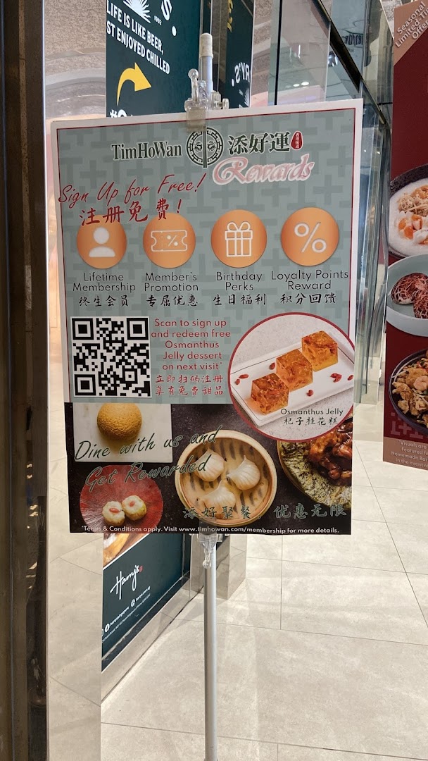 A promotional sign for Tim Ho Wan's rewards program, featuring membership benefits and food images.
