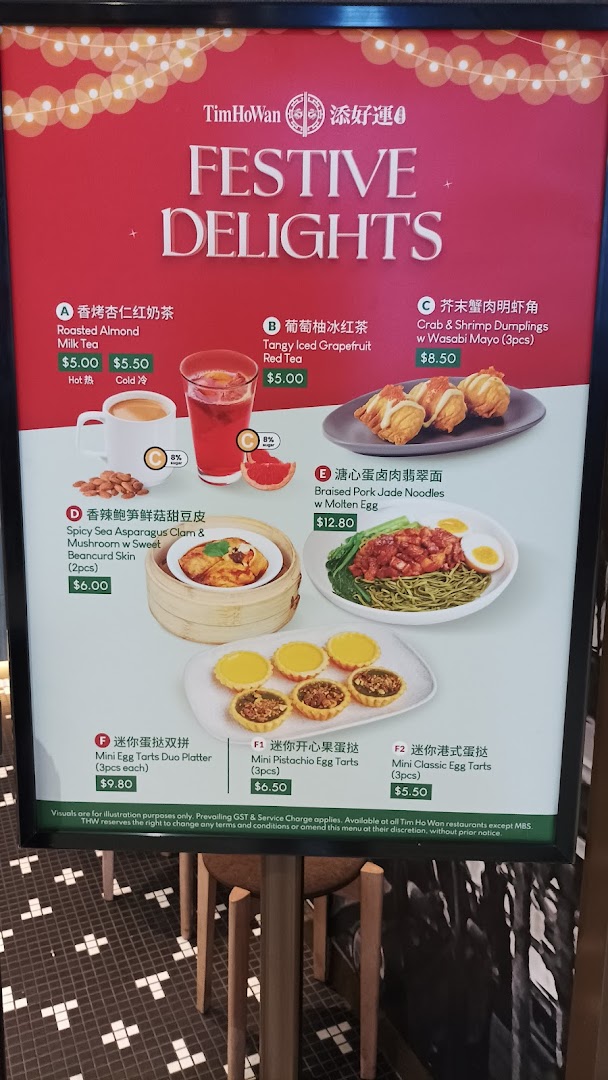 A vibrant red menu board showcasing Tim Ho Wan's 'Festive Delights' with various dim sum, noodles, drinks, and desserts.