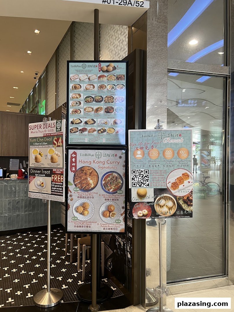 Tim Ho Wan's shop entrance featuring multiple display stands with menus, special deals, and membership information.