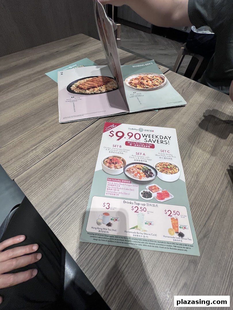 A table with Tim Ho Wan menus, featuring a 'Weekday Savers' special offer and drink top-ups.