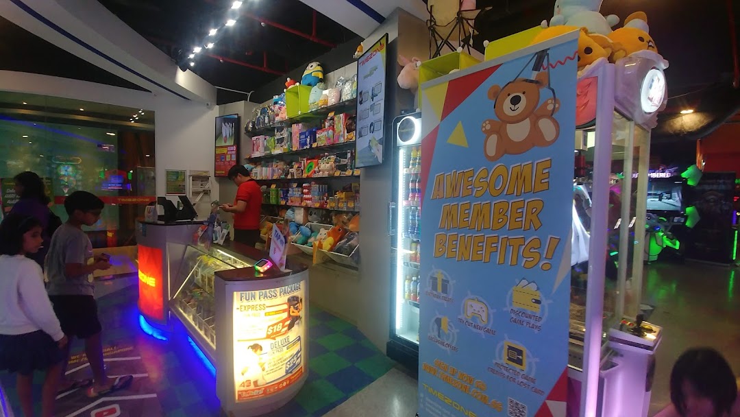 Interior view of Timezone arcade showing the prize counter, game area, and a membership benefits banner.
