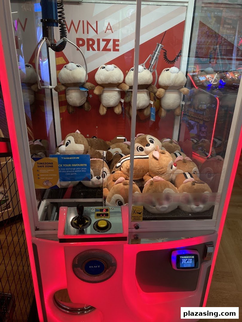 A brightly lit claw machine filled with plush toys, inviting players to win a prize.