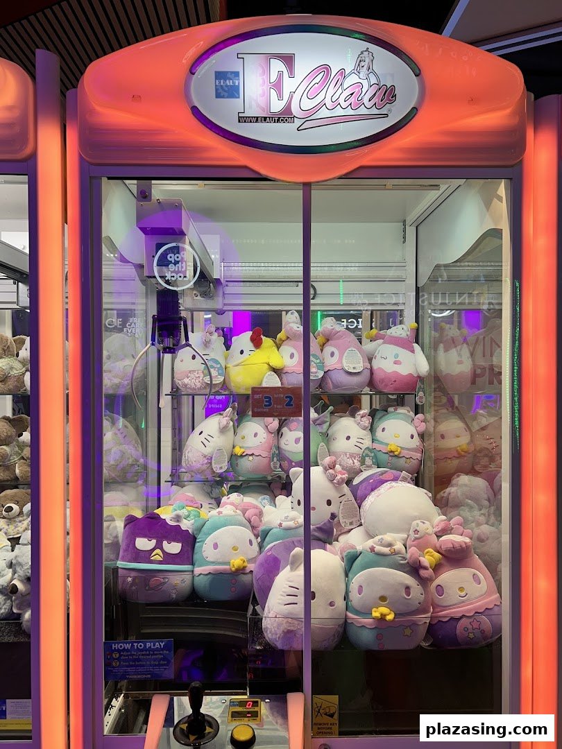 A brightly lit claw machine filled with various colorful plush toys, ready to be won.