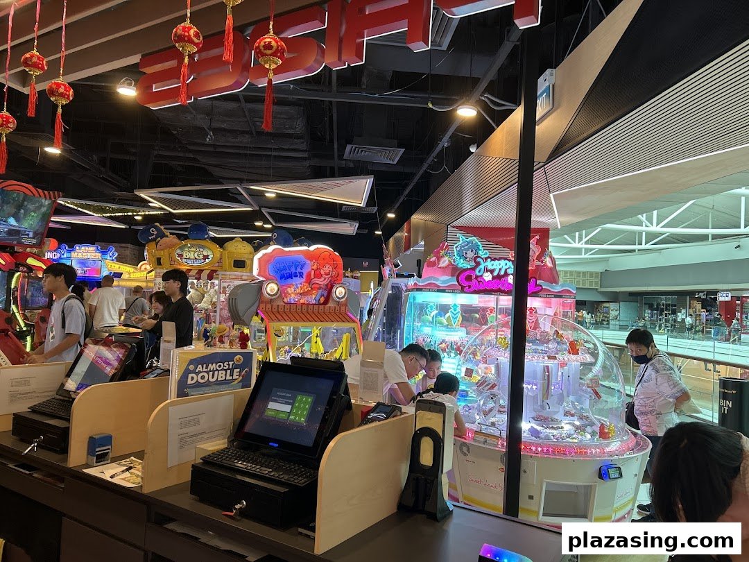An vibrant arcade interior with various games, claw machines, and people enjoying the entertainment.