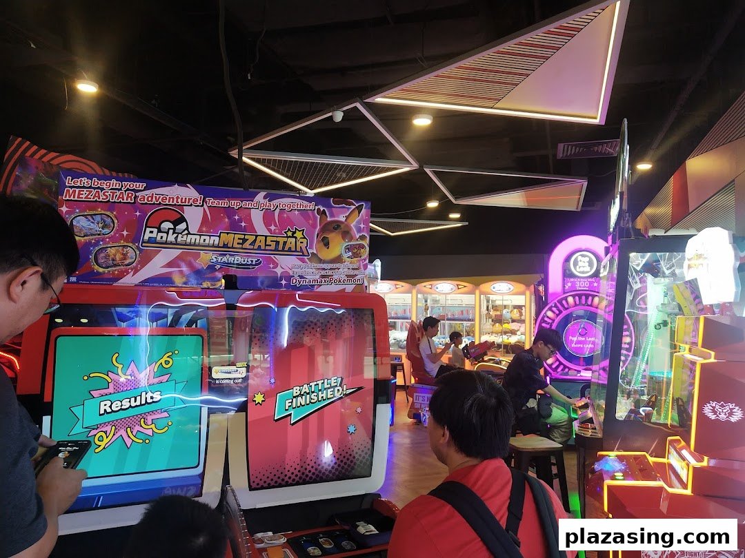People enjoying various arcade games, including Pokémon MEZASTAR, at Timezone Plaza Singapura.