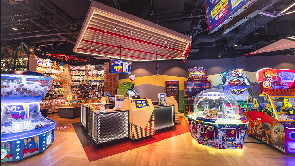 Vibrant interior of Timezone arcade featuring various games, a prize counter, and bright lighting.