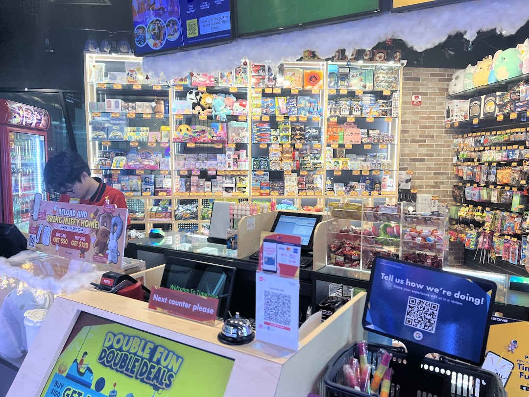 An interior view of Timezone's prize counter area, featuring merchandise displays and promotional signage.