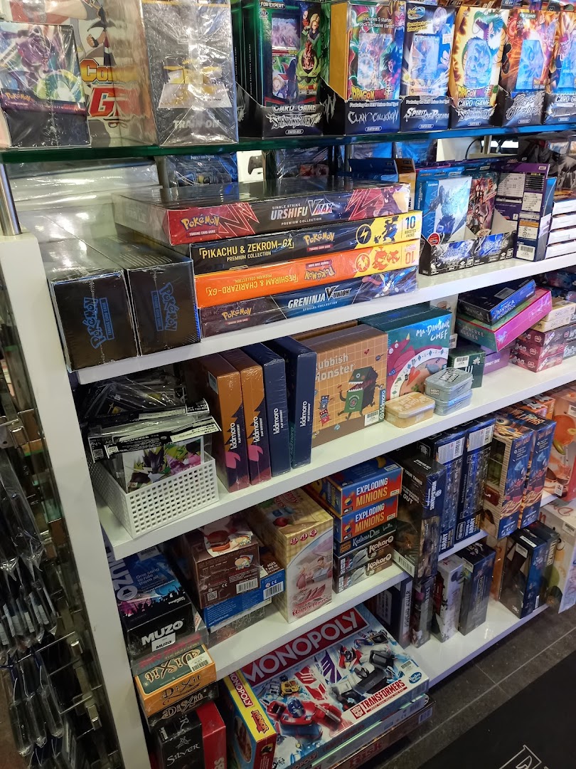 Shelves filled with a wide variety of board games, card games, and collectible items.
